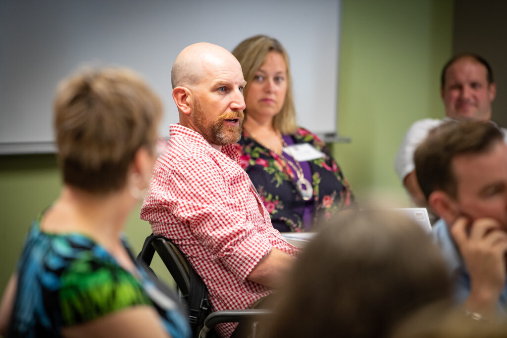 Man gives feedback during session.