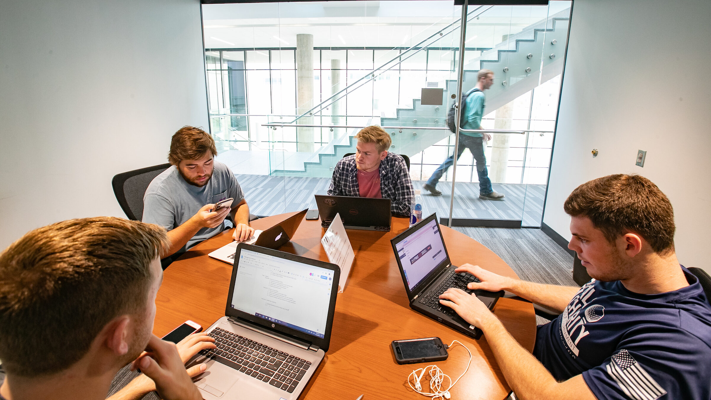 Group of students sits in small study space.