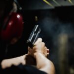 Back of someone's head as they shoot at shooting range.