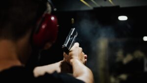 Back of someone's head as they shoot at shooting range.