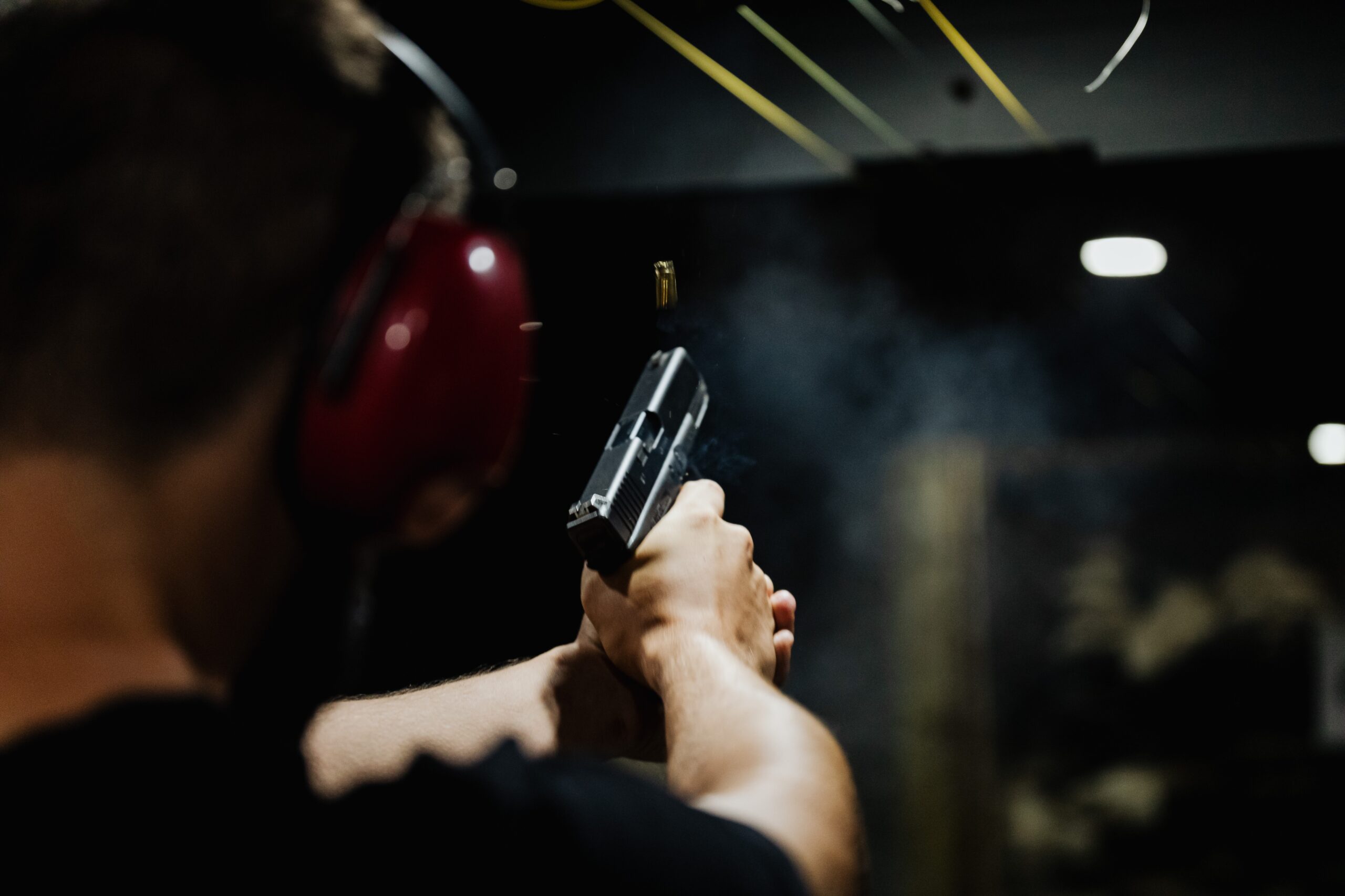 Back of someone's head as they shoot at shooting range.