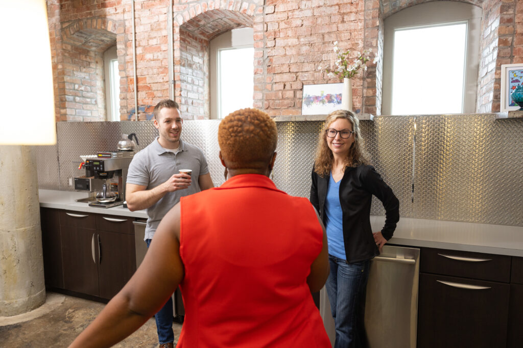 Three people gather in Brick City's kitchen.