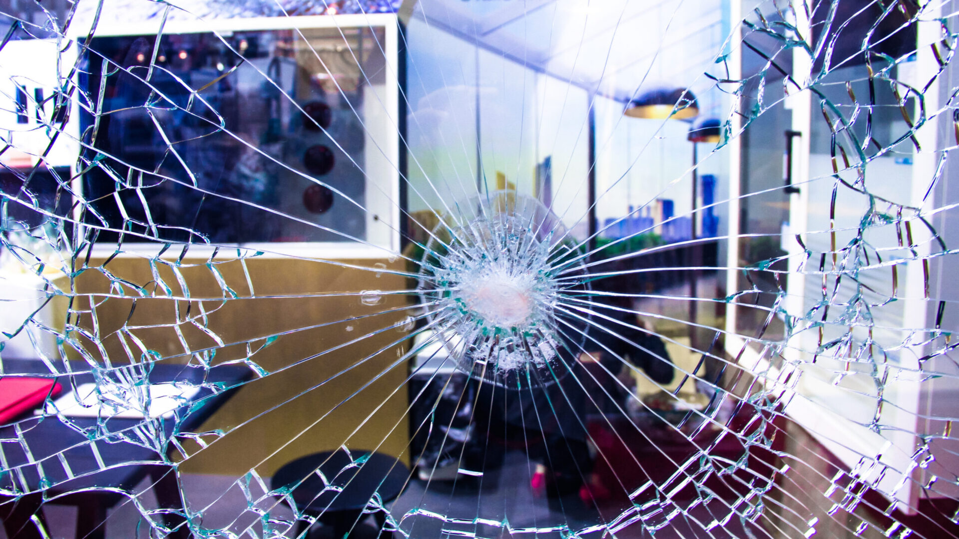 Broken glass on office window, seemingly from a bullet