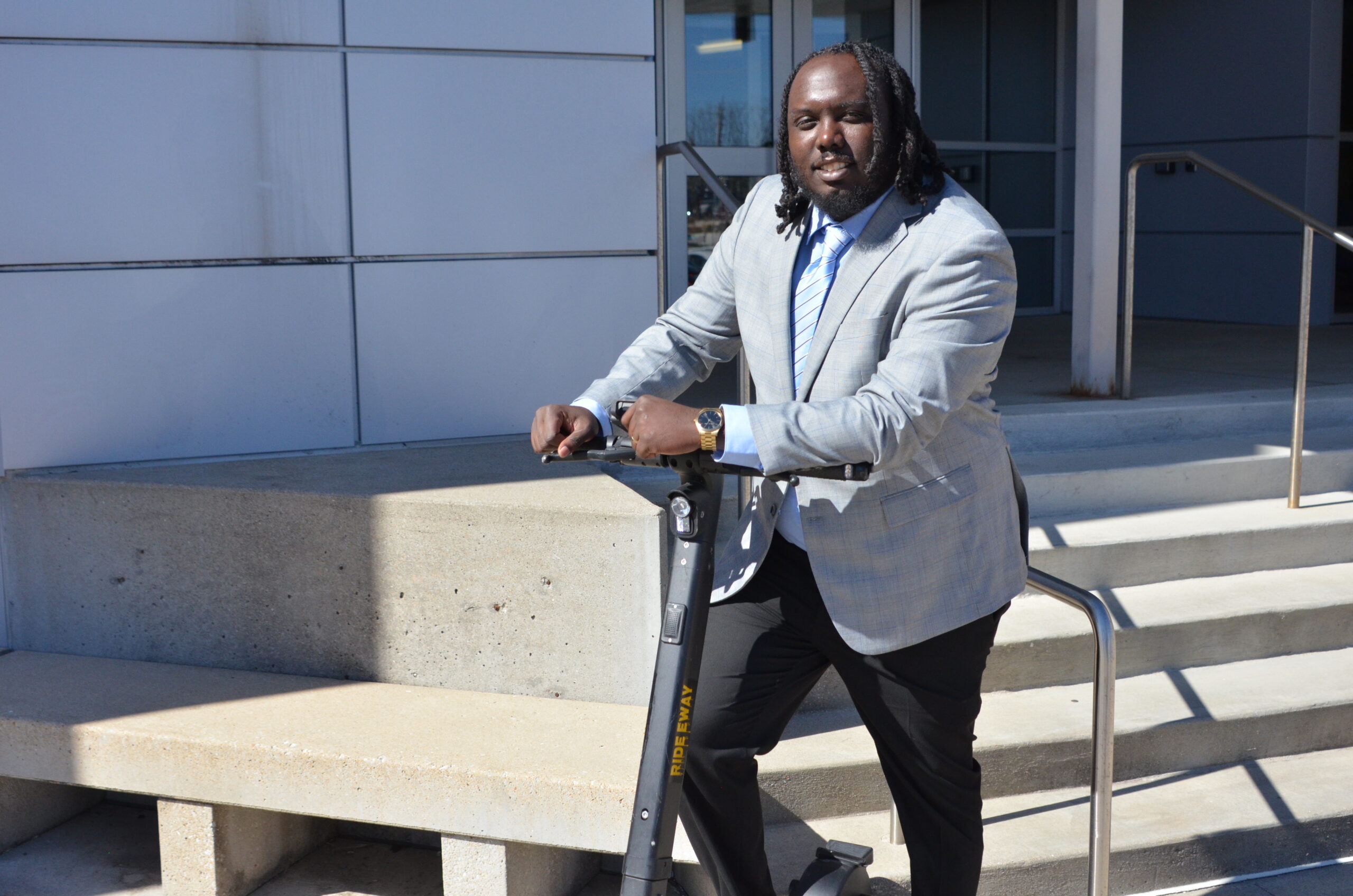 Marquez Williams stands with his eway scooter at efactory.