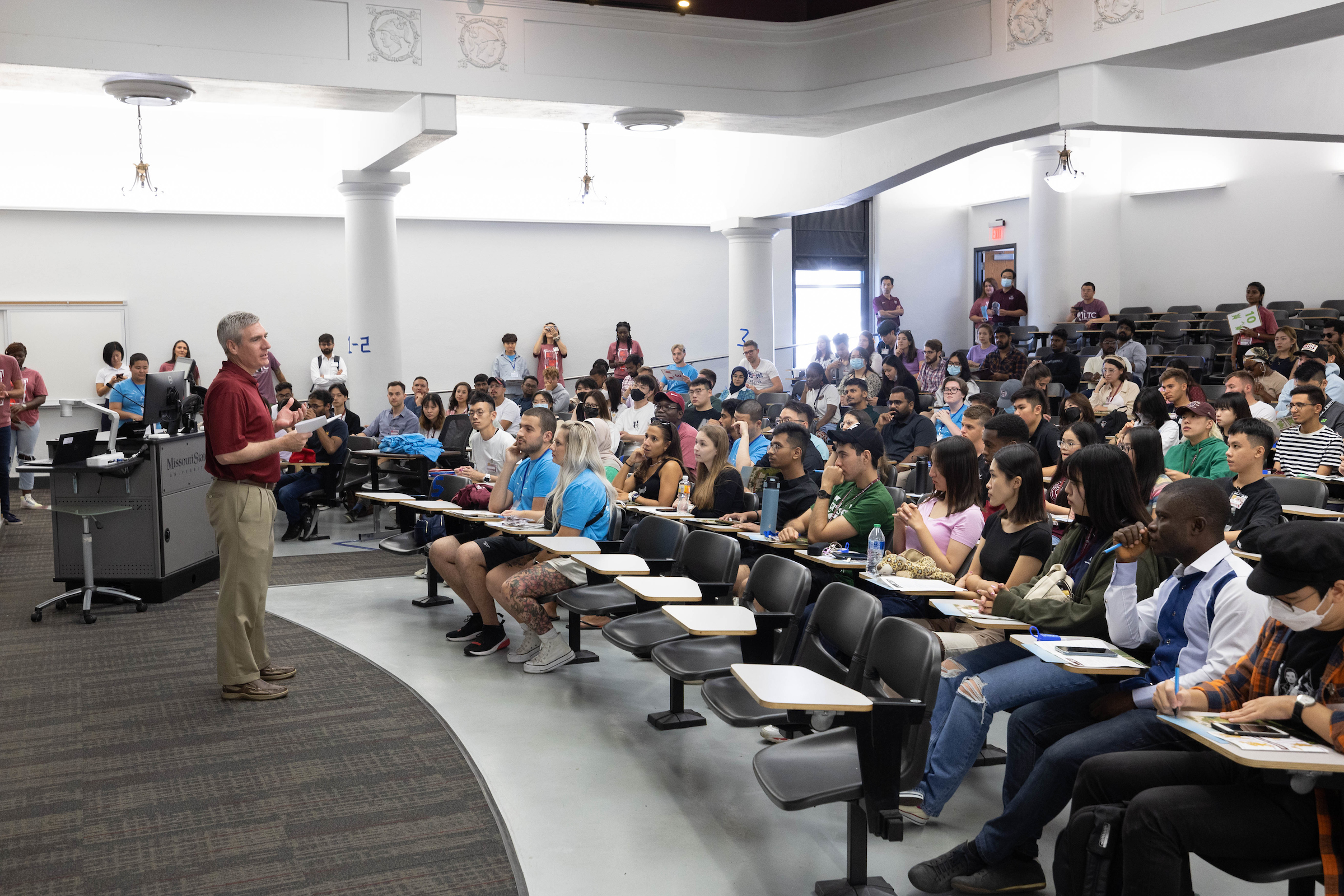 Classroom full of students listening to instructor.