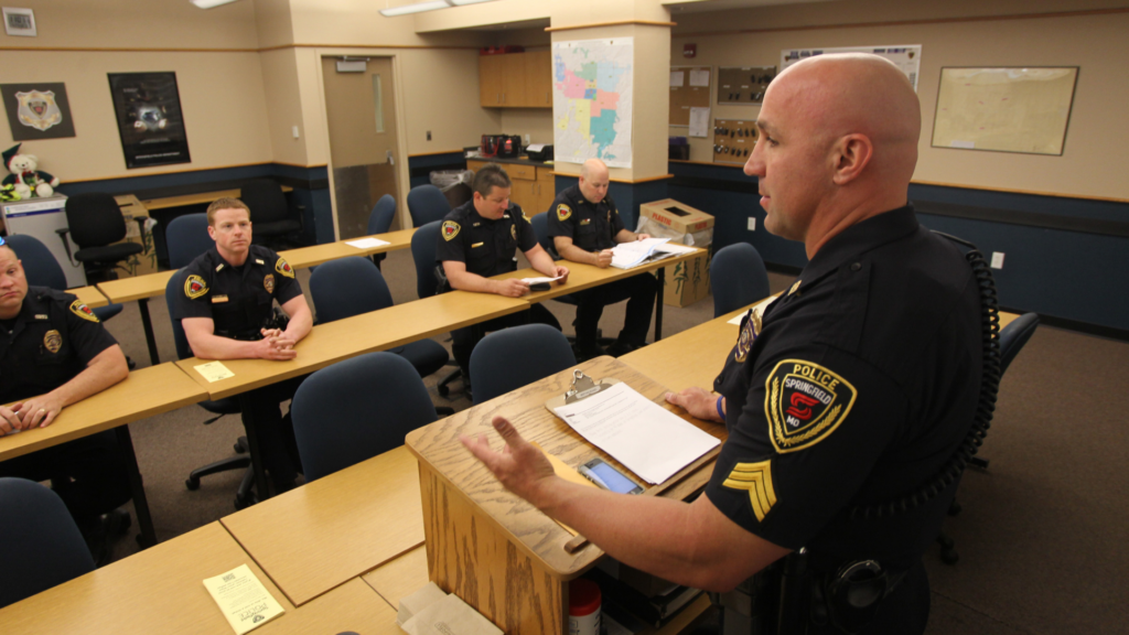 Room full of Springfield Police officers with one speaking at podium