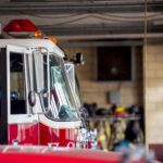 Closeup shot of a firetruck with an open door and a blurred background