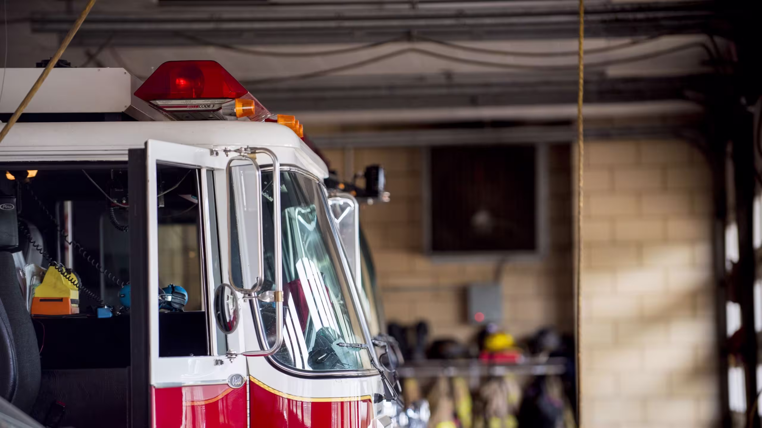 Closeup shot of a firetruck with an open door and a blurred background