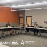 Instructor Larry Stock making a presentation to 3 women and a man in a training room. Sponsor logos for MSU, efactory, Missouri SBDC and Leadership Springfield are shown.