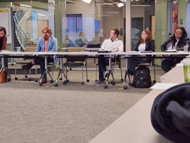 People listen in conference room