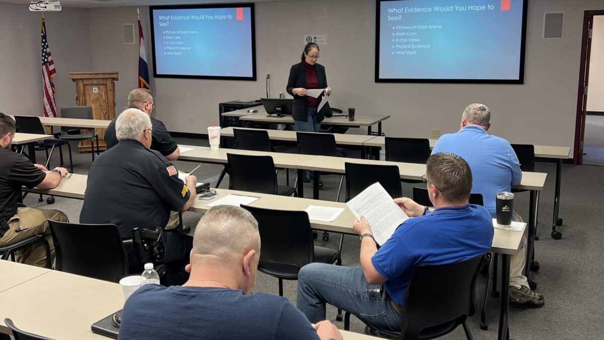 officers sitting in classroom with female instructor teaching