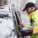 police officer at window of car on traffic stop