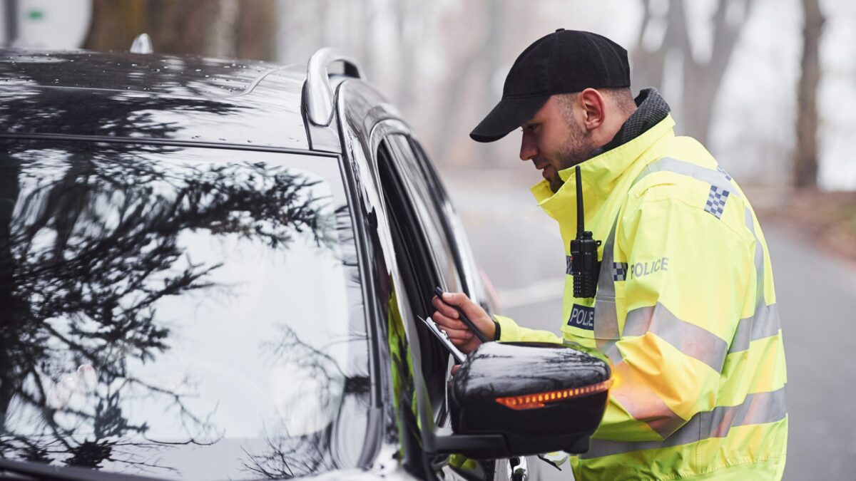 police officer at window of car on traffic stop