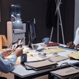 two males sitting at desk looking over case files