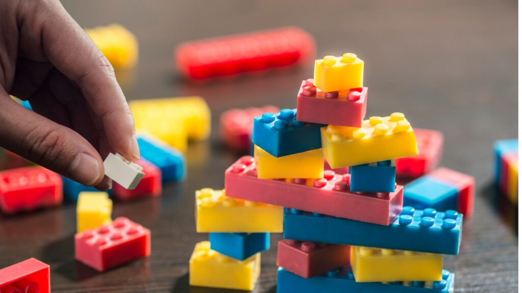 Hands placing LEGOs