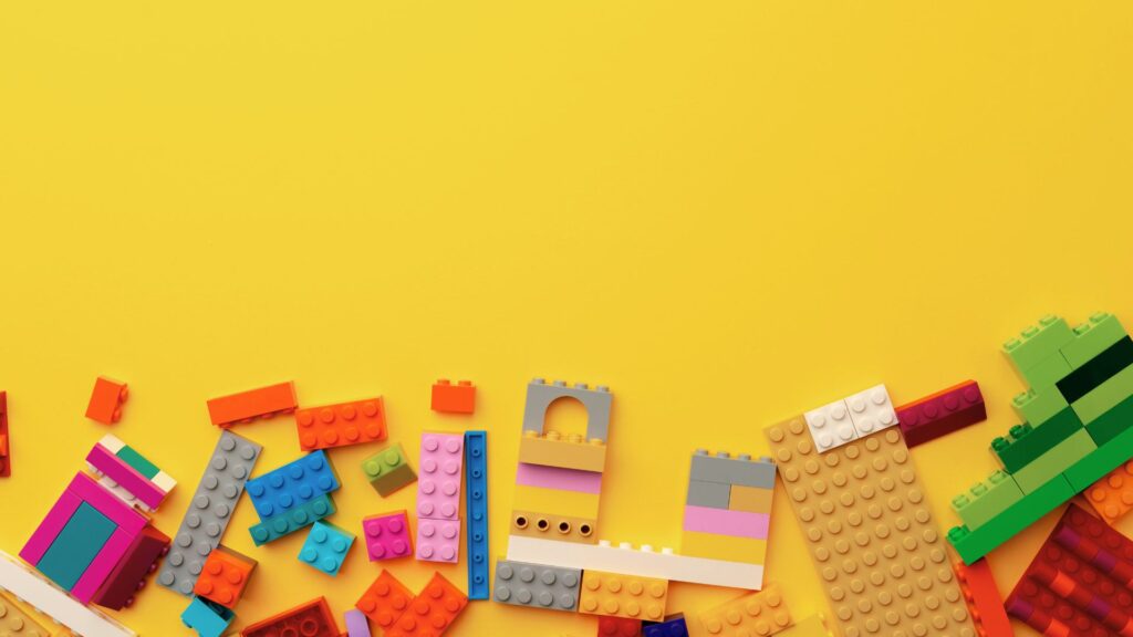 Scattered LEGOs on yellow table