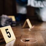 crime scene with number 5 and bullet laying on floor