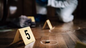 crime scene with number 5 and bullet laying on floor