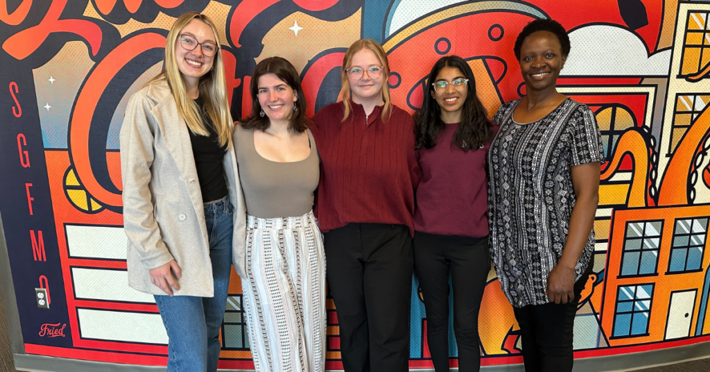 efactory student workers outside Plaster Center mural