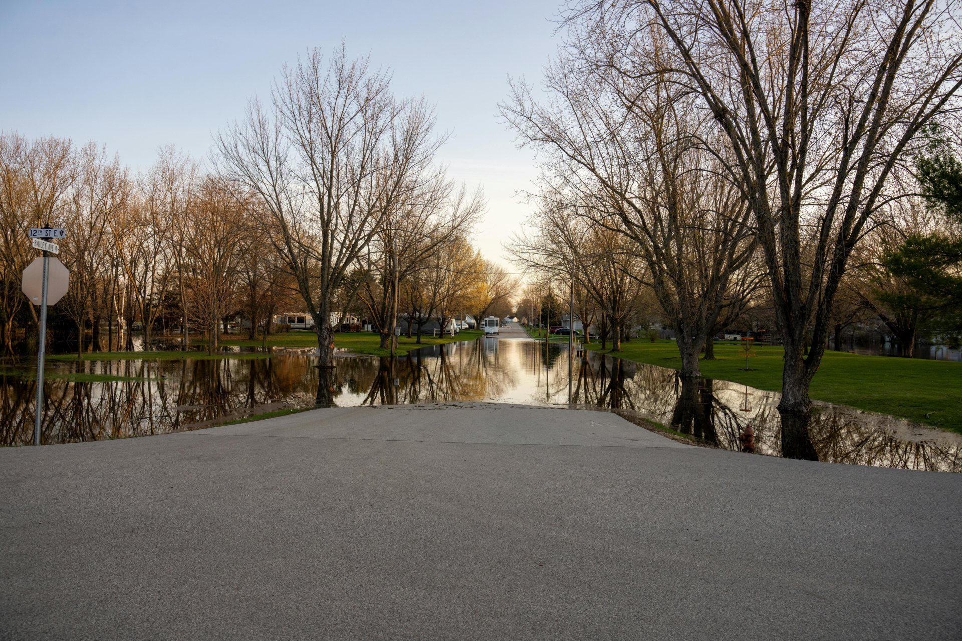 Picture of a flooded street with houses in the background.