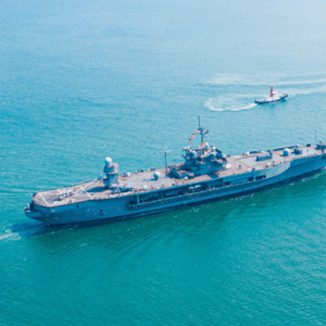 Navy ship on a body of water.