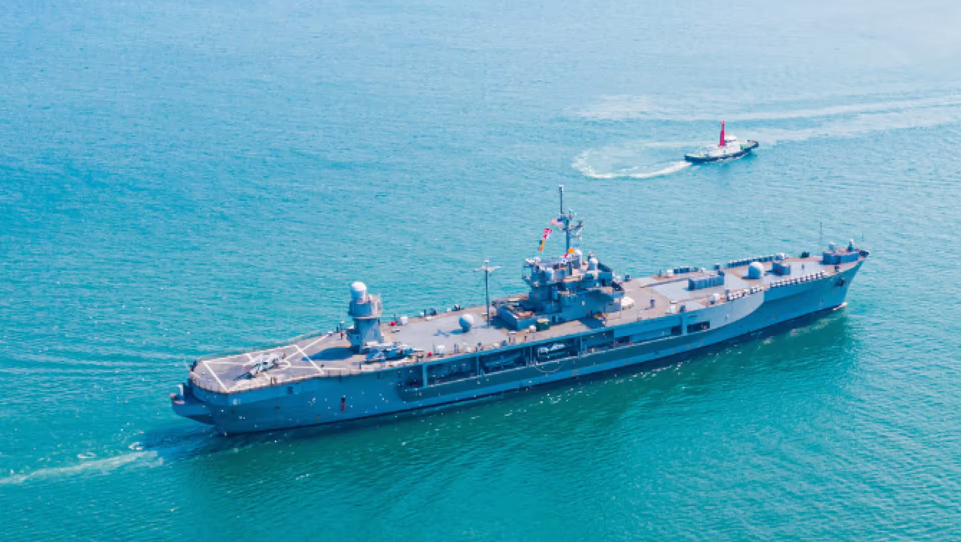 Navy ship on a body of water.