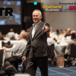 Steve Baker presenting a seminar to a roomful of people seated at tables.