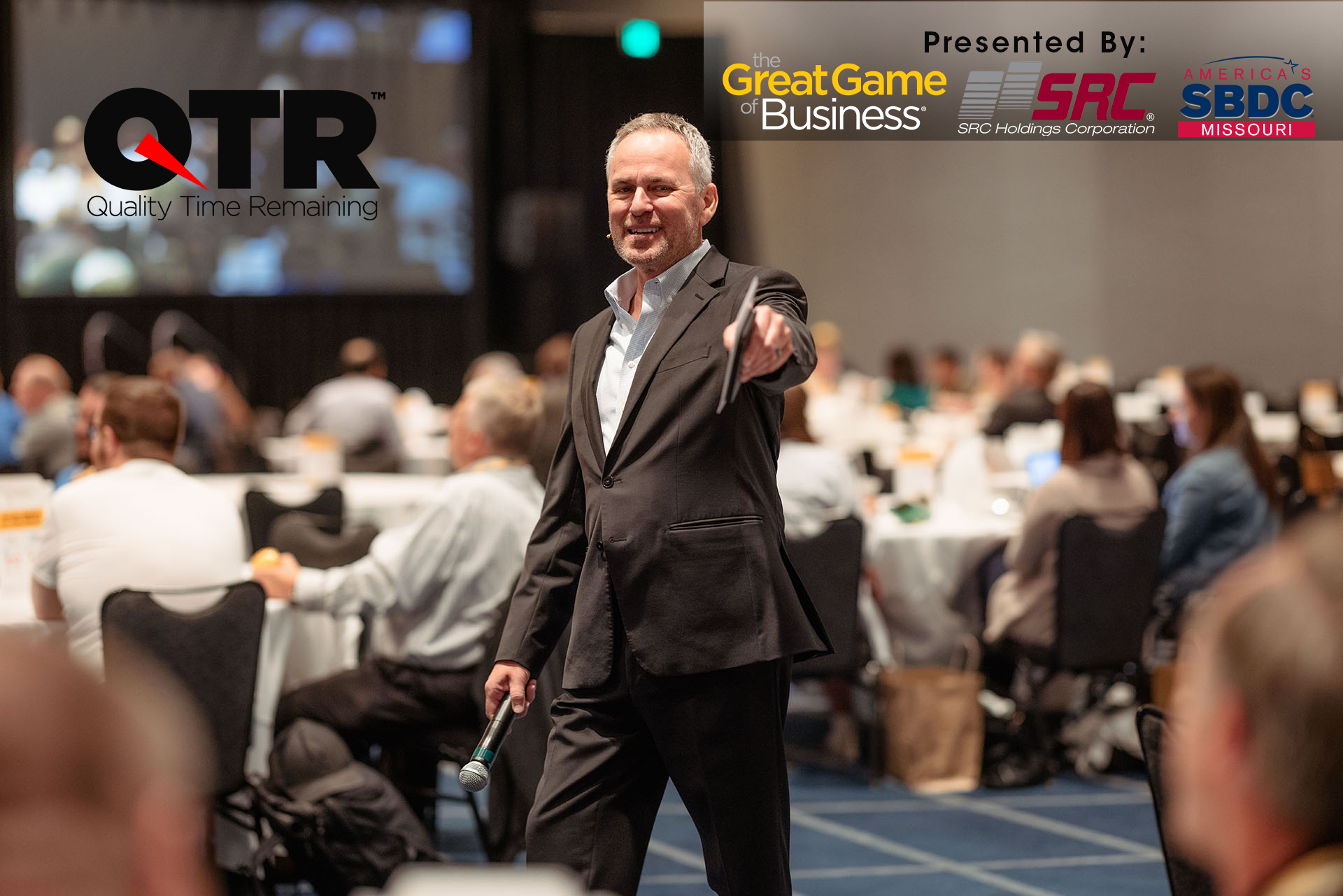 Steve Baker presenting a seminar to a roomful of people seated at tables.