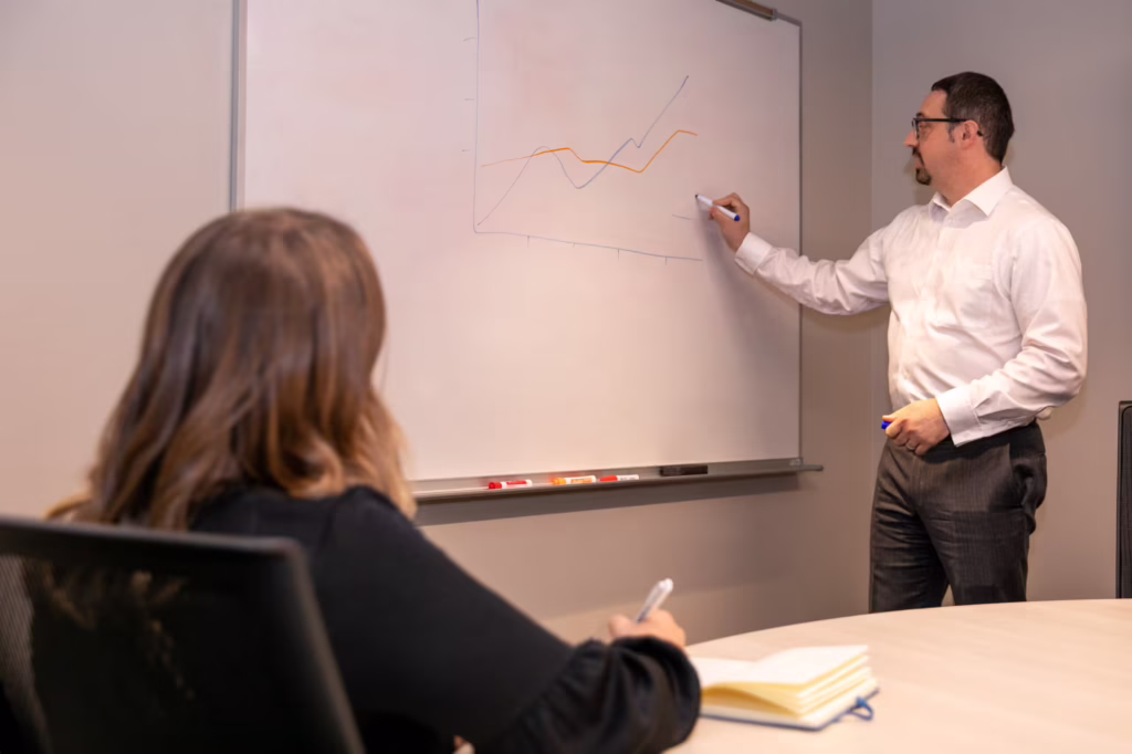 Man draws on white board