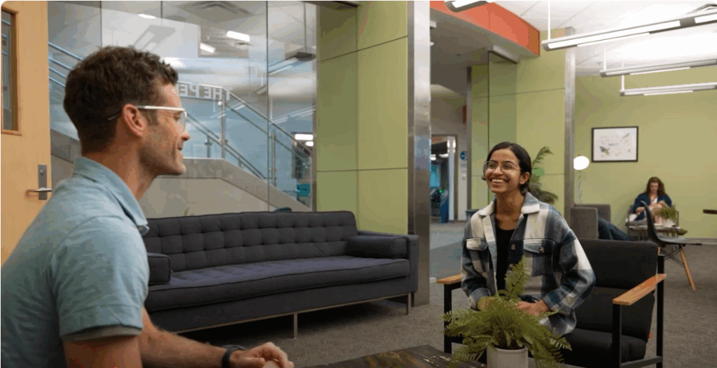 Man and woman sit and smile