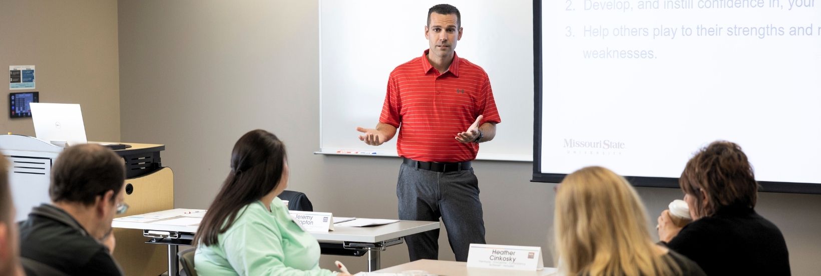 Training room with man speaking.