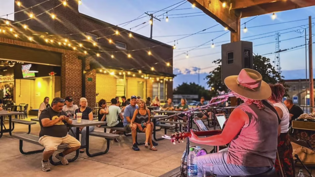 Crowd sits on patio listening to music