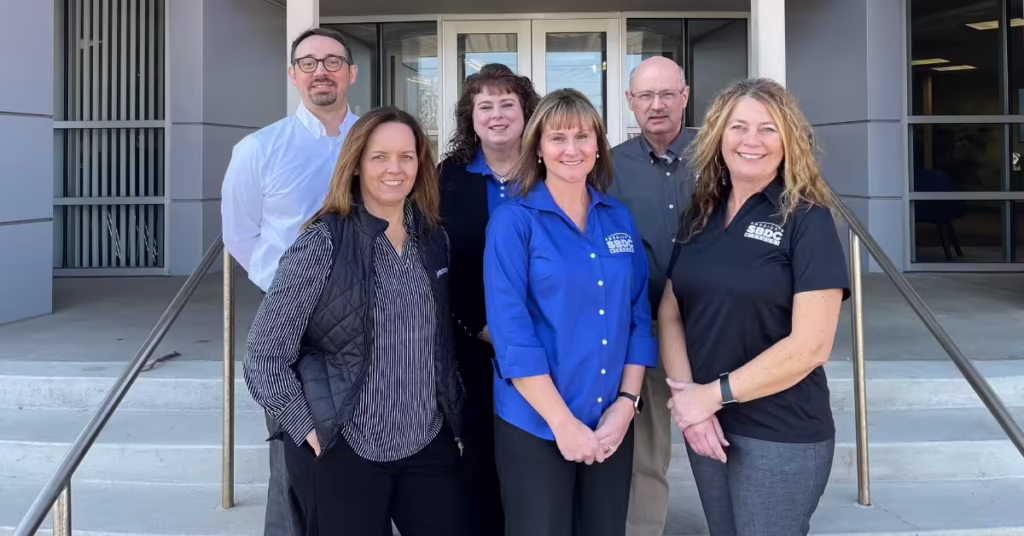 Lance, Tara, Mel, Amy, Chrystal and Sandra pose in front of Plaster Center