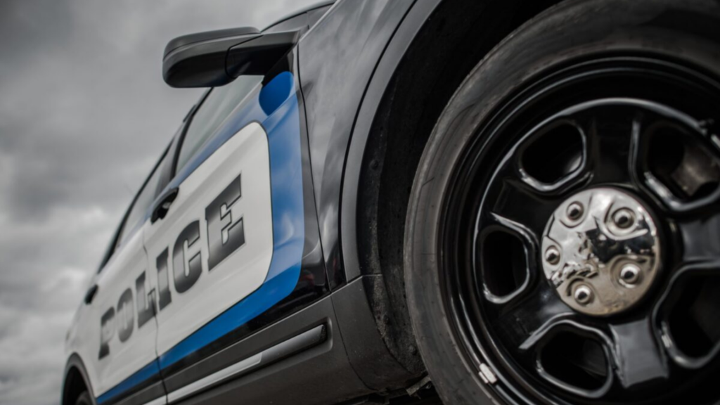 picture of police car close up with wheel and door staying police
