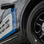 picture of police car close up with wheel and door staying police