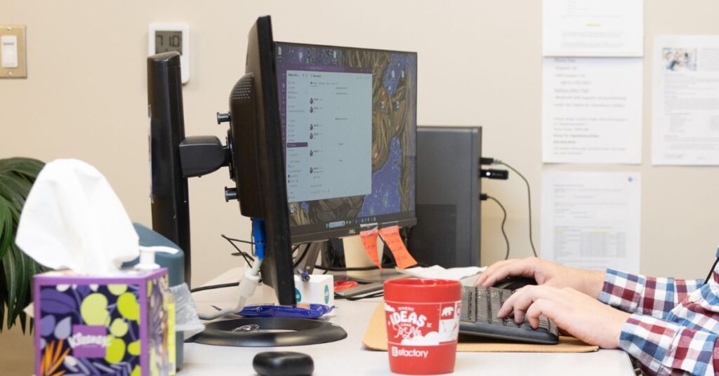 Hands type on keyboard.