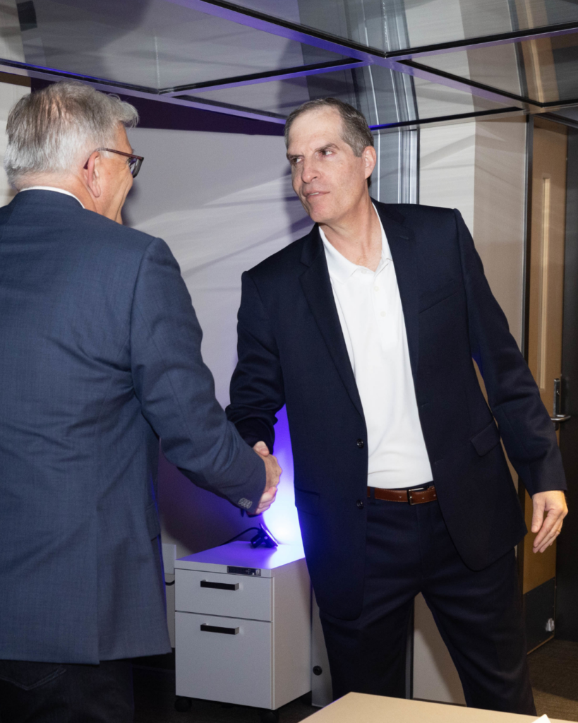 Allen Kunkel shakes hand with man
