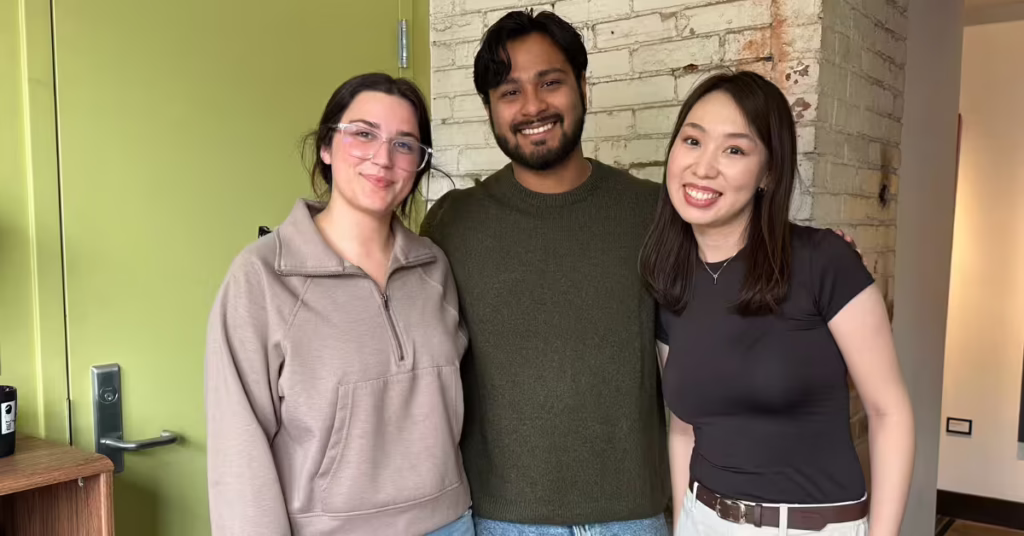 Three students smiling