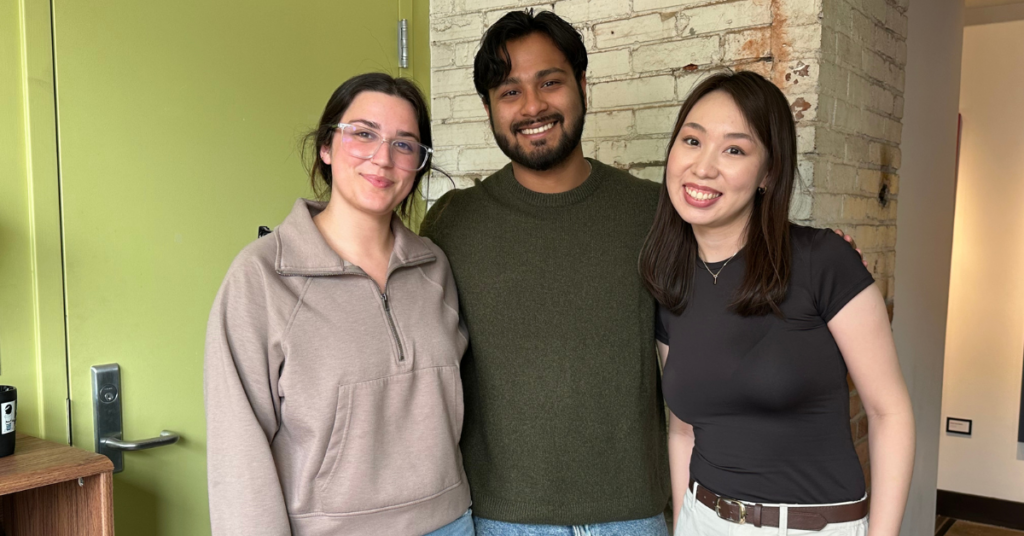 Three students smiling