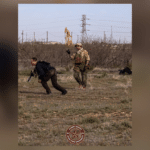 alerrt instructor in field with student with training rifle