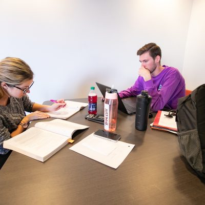 Young man and woman study together.