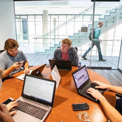 Group of students sits in small study space.